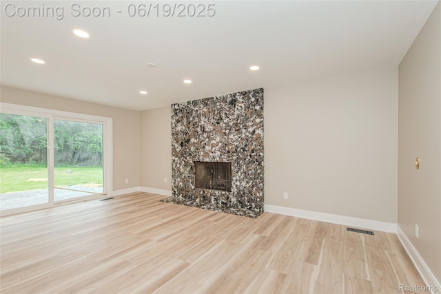 21993 Riverview Dr, Bloomfield Hills, MI 48025 - unfurnished living room with light wood finished floors, recessed lighting, and a fireplace