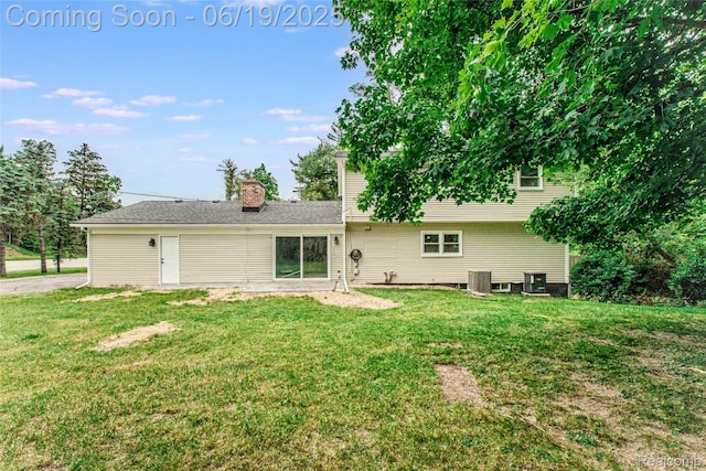 21993 Riverview Dr, Bloomfield Hills, MI 48025 - rear view of house with a yard and a chimney
