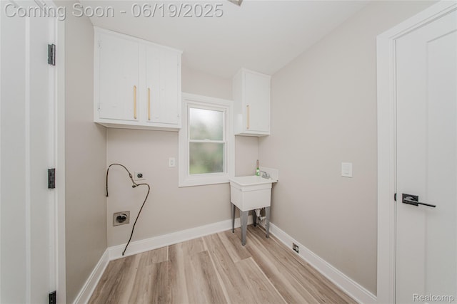 21993 Riverview Dr, Bloomfield Hills, MI 48025 - laundry area with cabinet space, light wood-style floors, and electric dryer hookup