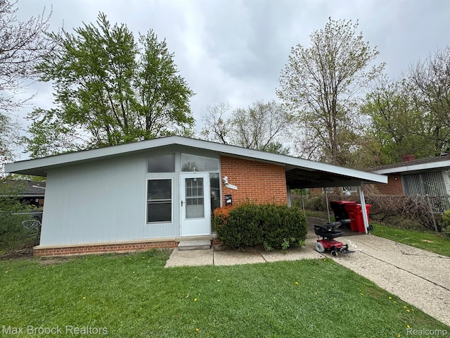 29234 Fairfax St, Southfield, MI 48076 - view of front facade with a front yard, a carport, and concrete driveway