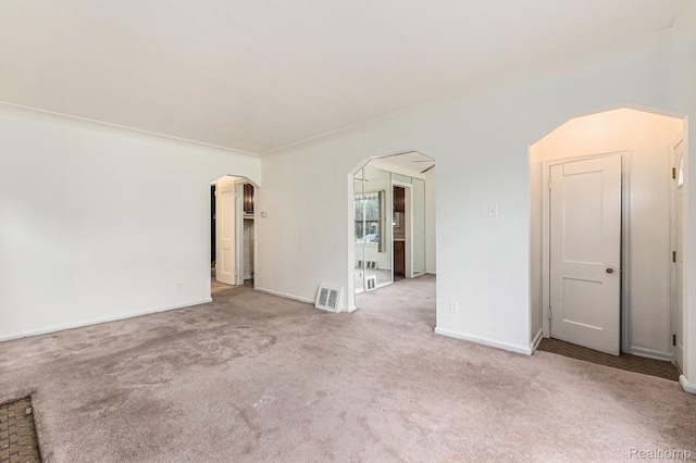 15377 Heyden St, Detroit, MI 48223 - carpeted empty room featuring arched walkways and baseboards