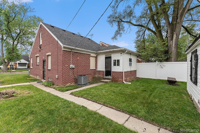 15377 Heyden St, Detroit, MI 48223 - view of front of home with central AC, a shingled roof, brick siding, and entry steps