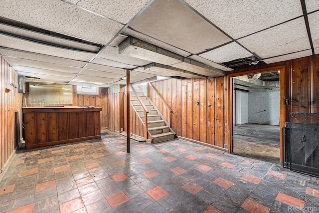 15377 Heyden St, Detroit, MI 48223 - basement featuring bar, wooden walls, stairway, baseboards, and a paneled ceiling