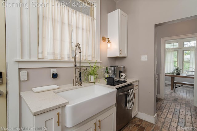 8604 La Salle Blvd, Detroit, MI 48206 - kitchen with dishwashing machine, brick flooring, and white cabinetry