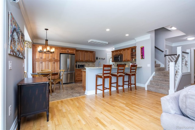 6081 Byram Lake Dr, Linden, MI 48451 - kitchen featuring stainless steel appliances, a peninsula, crown molding, tasteful backsplash, and open floor plan