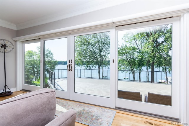 6081 Byram Lake Dr, Linden, MI 48451 - doorway featuring ornamental molding, a water view, and wood finished floors
