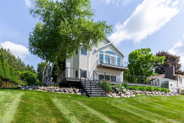6081 Byram Lake Dr, Linden, MI 48451 - back of property featuring stairs, a balcony, and a lawn