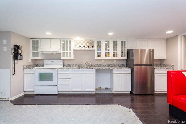 6081 Byram Lake Dr, Linden, MI 48451 - kitchen with freestanding refrigerator, white electric range oven, under cabinet range hood, white cabinetry, and recessed lighting