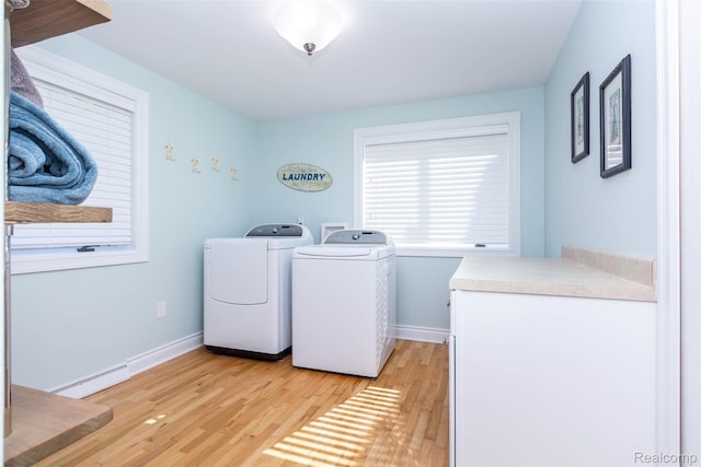 6081 Byram Lake Dr, Linden, MI 48451 - laundry room with baseboard heating, washer and dryer, and light wood finished floors