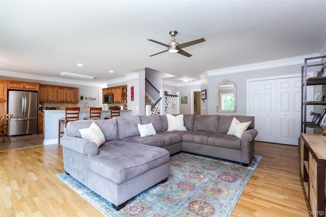 6081 Byram Lake Dr, Linden, MI 48451 - living room with ceiling fan, ornamental molding, light wood finished floors, stairway, and recessed lighting