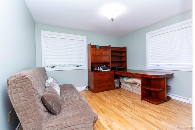6081 Byram Lake Dr, Linden, MI 48451 - office area featuring a baseboard heating unit and light wood-type flooring