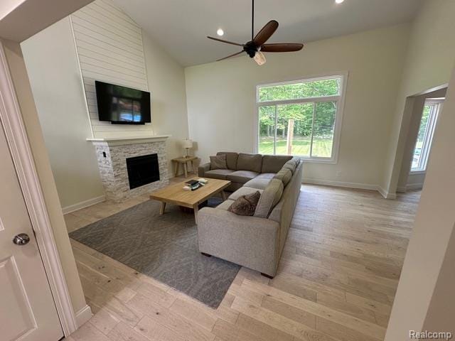 1727 Pero Lake Rd, Lapeer, MI 48446 - living area with a fireplace, a ceiling fan, light wood-type flooring, recessed lighting, and baseboards