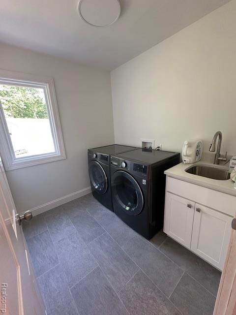 1727 Pero Lake Rd, Lapeer, MI 48446 - washroom featuring washer and dryer, cabinet space, dark tile patterned floors, and baseboards