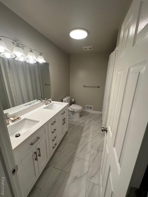 1727 Pero Lake Rd, Lapeer, MI 48446 - full bath with marble look tiles, toilet, double vanity, and curtained shower