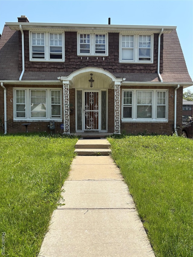 4206 Devonshire Rd, Lincoln Park, MI 48224 - view of front of house with brick siding and a front lawn
