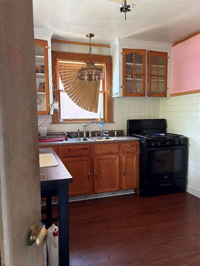 4206 Devonshire Rd, Lincoln Park, MI 48224 - kitchen with black range with gas stovetop, a sink, crown molding, glass insert cabinets, and brown cabinetry