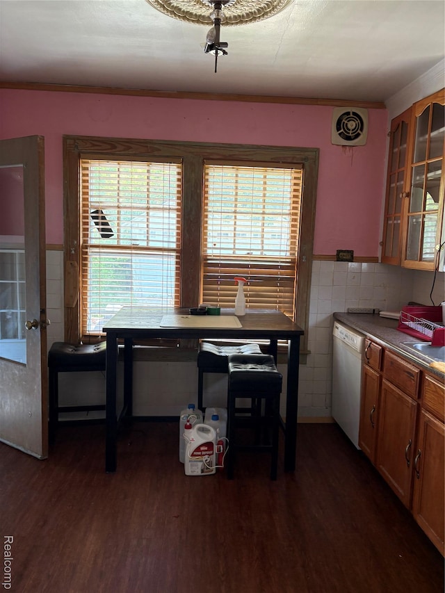 4206 Devonshire Rd, Lincoln Park, MI 48224 - kitchen with white dishwasher, dark wood-style floors, tile walls, glass insert cabinets, and a wainscoted wall