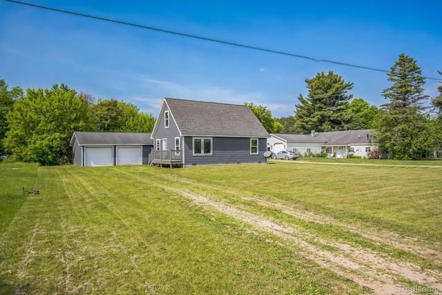 6195 Falkenbury Rd, North Branch, MI 48461 - back of house with a lawn, a detached garage, an outdoor structure, and a shingled roof