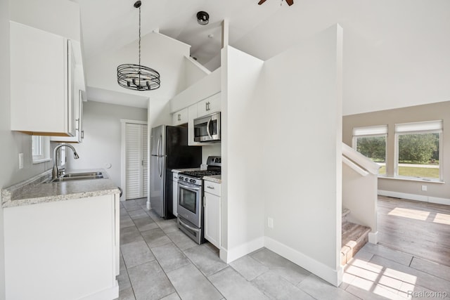 6195 Falkenbury Rd, North Branch, MI 48461 - kitchen featuring stainless steel appliances, a sink, high vaulted ceiling, white cabinets, and light tile patterned floors