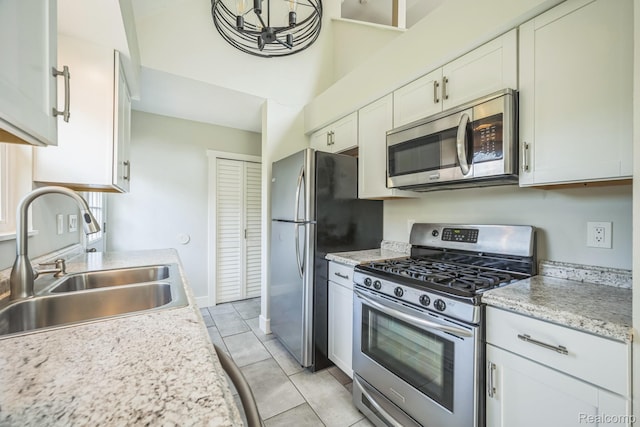 6195 Falkenbury Rd, North Branch, MI 48461 - kitchen featuring stainless steel appliances, a sink, light countertops, white cabinetry, and light tile patterned floors