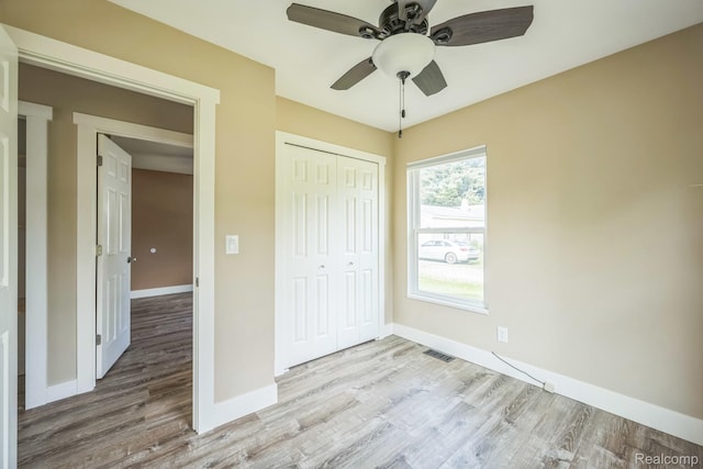 6195 Falkenbury Rd, North Branch, MI 48461 - unfurnished bedroom with wood finished floors, a closet, baseboards, and a ceiling fan