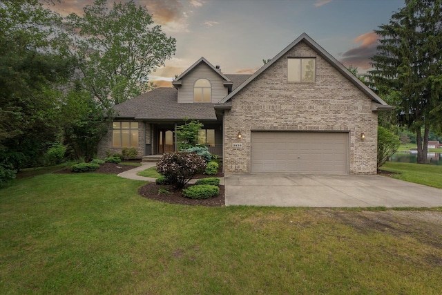 3438 Sandy Shore Dr, Metamora, MI 48455 - view of front of home with driveway, brick siding, a lawn, a shingled roof, and a garage