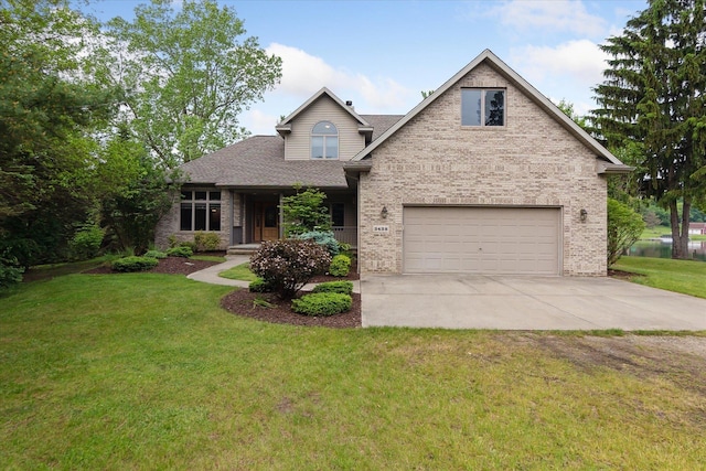 3438 Sandy Shore Dr, Metamora, MI 48455 - view of front of home with brick siding, driveway, an attached garage, a front yard, and a shingled roof