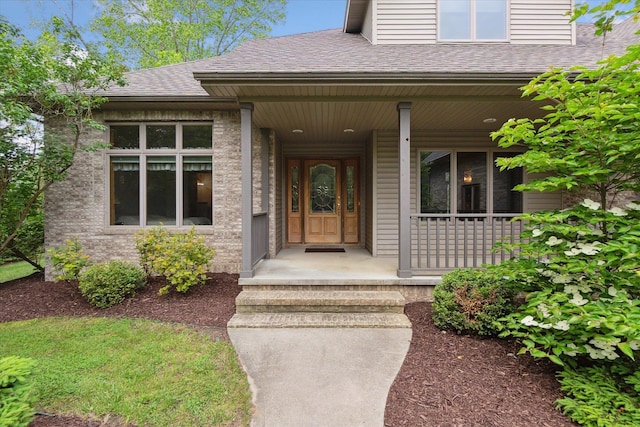 3438 Sandy Shore Dr, Metamora, MI 48455 - view of exterior entry featuring roof with shingles and covered porch