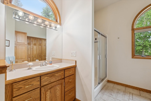 3438 Sandy Shore Dr, Metamora, MI 48455 - full bathroom featuring a shower with door, vanity, and baseboards