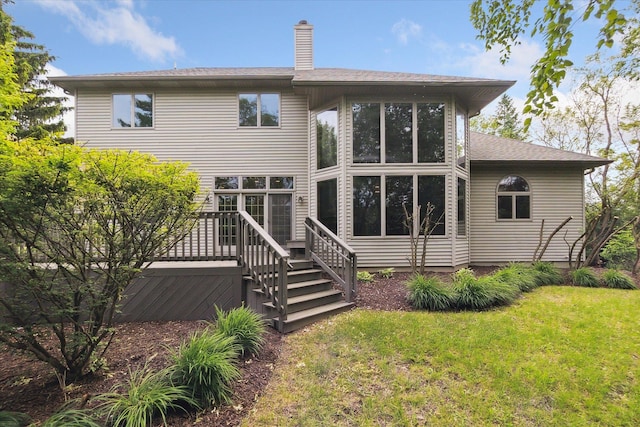 3438 Sandy Shore Dr, Metamora, MI 48455 - rear view of house with a lawn, a chimney, and a deck