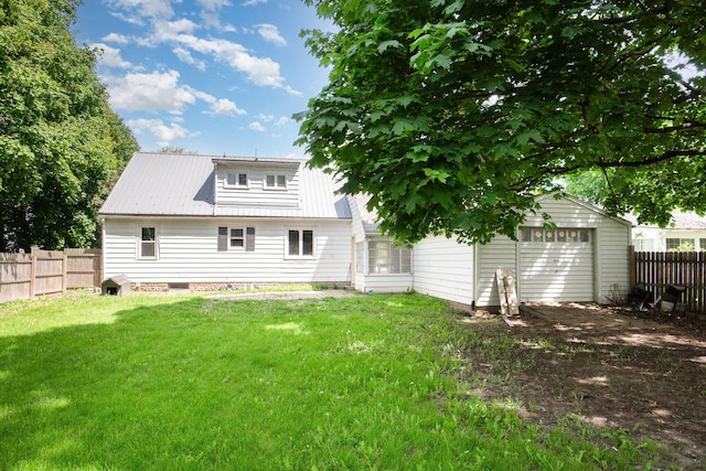2958 E Stewart Rd, Midland, MI 48640 - rear view of house featuring metal roof and a garage