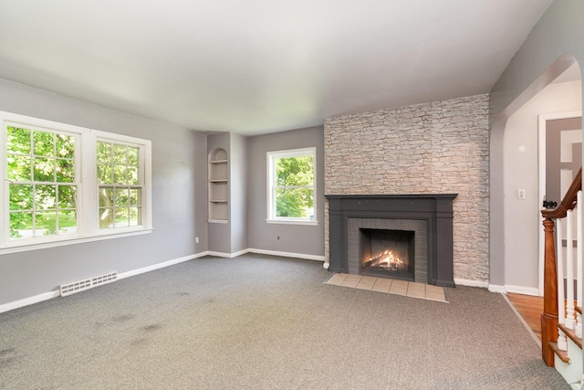 2958 E Stewart Rd, Midland, MI 48640 - unfurnished living room with a fireplace, carpet, baseboards, and stairway