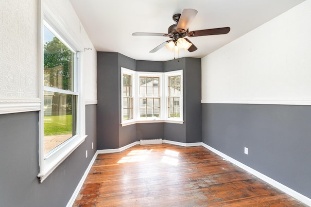 2958 E Stewart Rd, Midland, MI 48640 - unfurnished room featuring wood-type flooring, a ceiling fan, baseboards, and baseboard heating