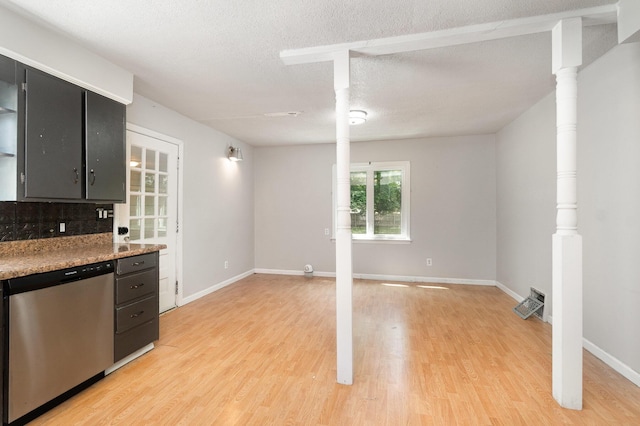 2958 E Stewart Rd, Midland, MI 48640 - kitchen with dishwasher, light wood-style floors, dark cabinets, baseboards, and a textured ceiling