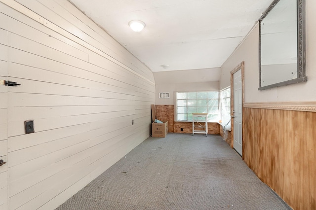 2958 E Stewart Rd, Midland, MI 48640 - unfurnished room with wood walls, carpet floors, and wainscoting