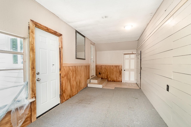2958 E Stewart Rd, Midland, MI 48640 - corridor with wood walls, carpet floors, and wainscoting