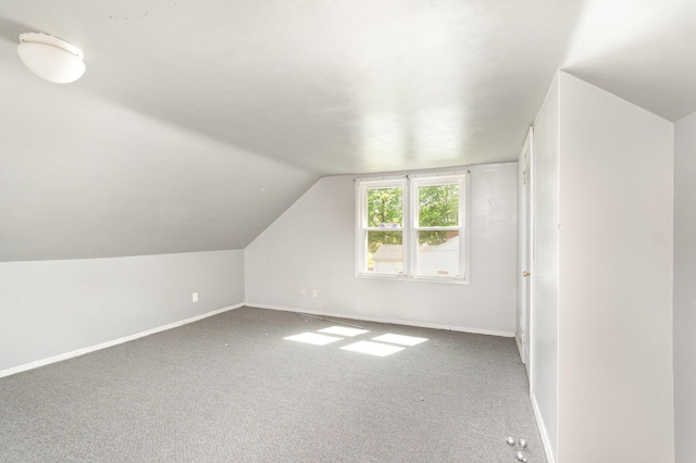 2958 E Stewart Rd, Midland, MI 48640 - additional living space with vaulted ceiling, carpet, and baseboards