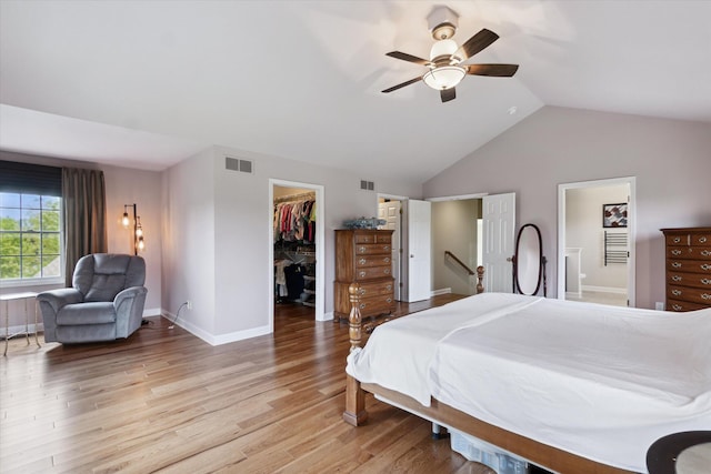 2056 Merlot Ct, Ann Arbor, MI 48108 - bedroom featuring a walk in closet, light wood-style floors, vaulted ceiling, a closet, and ceiling fan