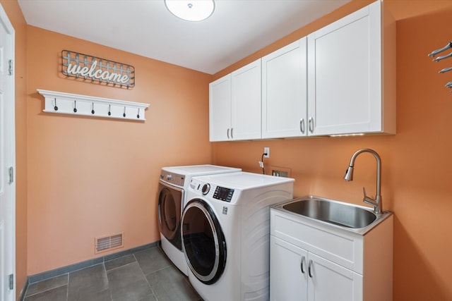 2056 Merlot Ct, Ann Arbor, MI 48108 - laundry area with cabinet space, washer and clothes dryer, and baseboards