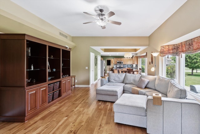 2056 Merlot Ct, Ann Arbor, MI 48108 - living area featuring light wood-style flooring, healthy amount of natural light, a ceiling fan, and baseboards