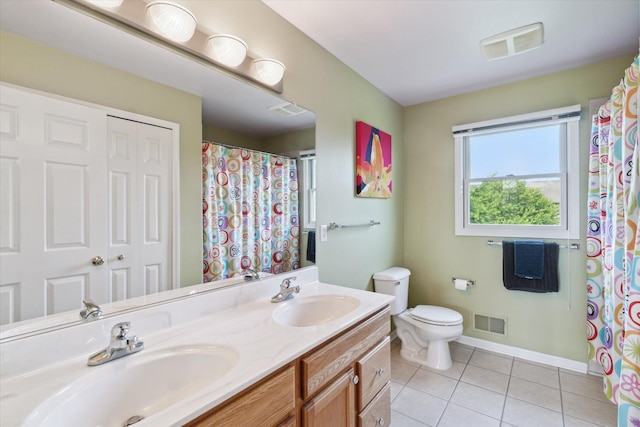 2056 Merlot Ct, Ann Arbor, MI 48108 - full bathroom with tile patterned floors, toilet, double vanity, baseboards, and a shower with curtain