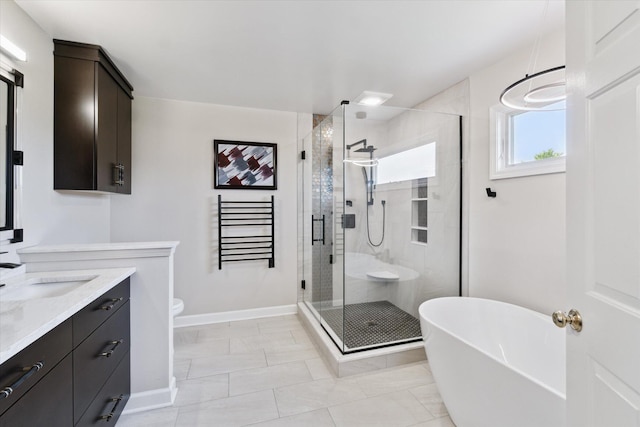 2056 Merlot Ct, Ann Arbor, MI 48108 - bathroom featuring vanity, a soaking tub, a stall shower, toilet, and baseboards