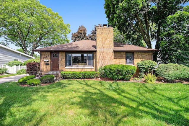 1018 Ruddiman Dr, North Muskegon, MI 49445 - view of front facade with brick siding and a chimney