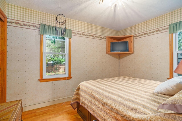 1018 Ruddiman Dr, North Muskegon, MI 49445 - bedroom featuring wood finished floors and baseboards