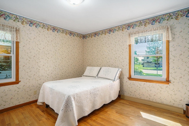 1018 Ruddiman Dr, North Muskegon, MI 49445 - bedroom with light wood-style flooring and baseboards
