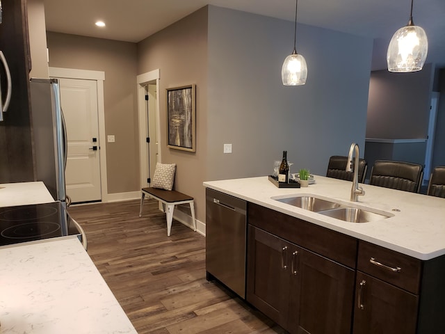 9421 Sassafras Trl Unit 76, Portage, MI 49002 - kitchen with stainless steel dishwasher, dark wood-type flooring, dark brown cabinetry, hanging light fixtures, and recessed lighting