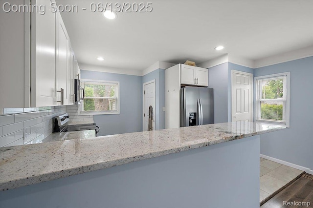 233 W 11 Mile Rd, Madison Heights, MI 48071 - kitchen featuring stainless steel appliances, tasteful backsplash, white cabinets, recessed lighting, and light stone countertops