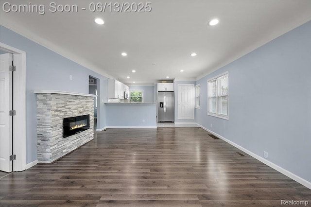 233 W 11 Mile Rd, Madison Heights, MI 48071 - unfurnished living room with plenty of natural light, recessed lighting, a fireplace, and dark wood finished floors