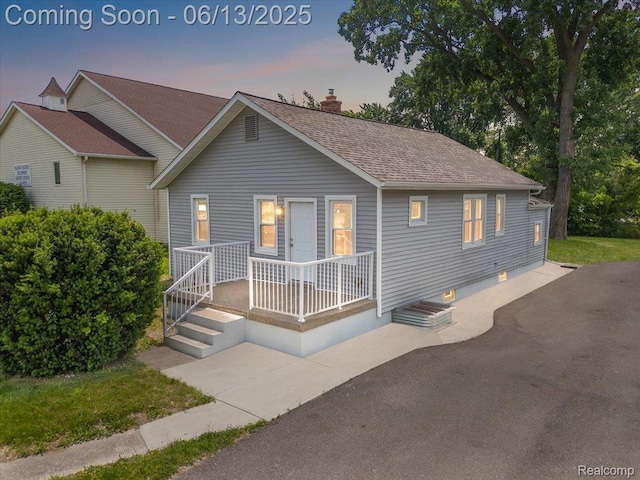 233 W 11 Mile Rd, Madison Heights, MI 48071 - view of front of house with a porch, roof with shingles, and a chimney