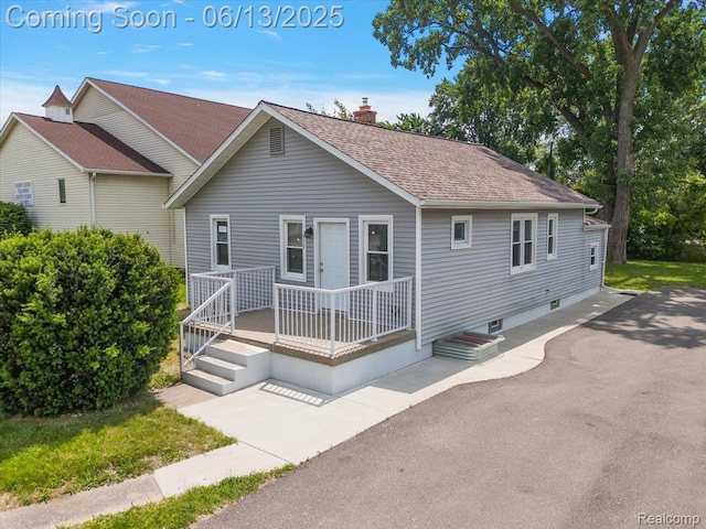 233 W 11 Mile Rd, Madison Heights, MI 48071 - view of front of home featuring a shingled roof, a chimney, and a patio